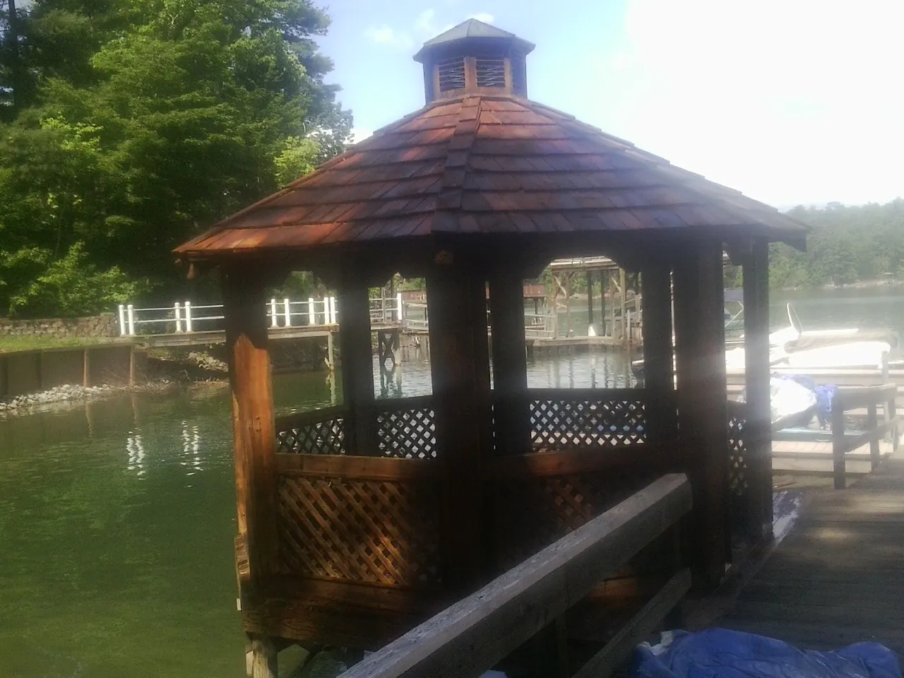 Cedar shake gazebo roof rebuilt on a lake dock in Waterford
